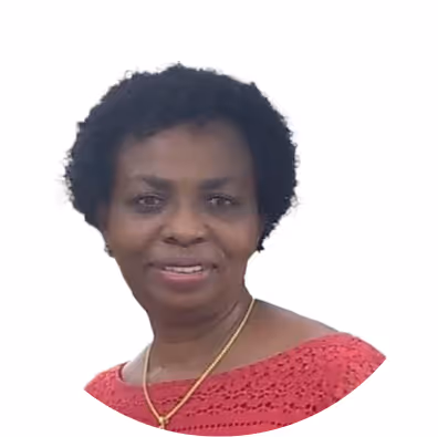 Smiling woman with short curly hair wearing a red crocheted top and gold necklace against a white background.